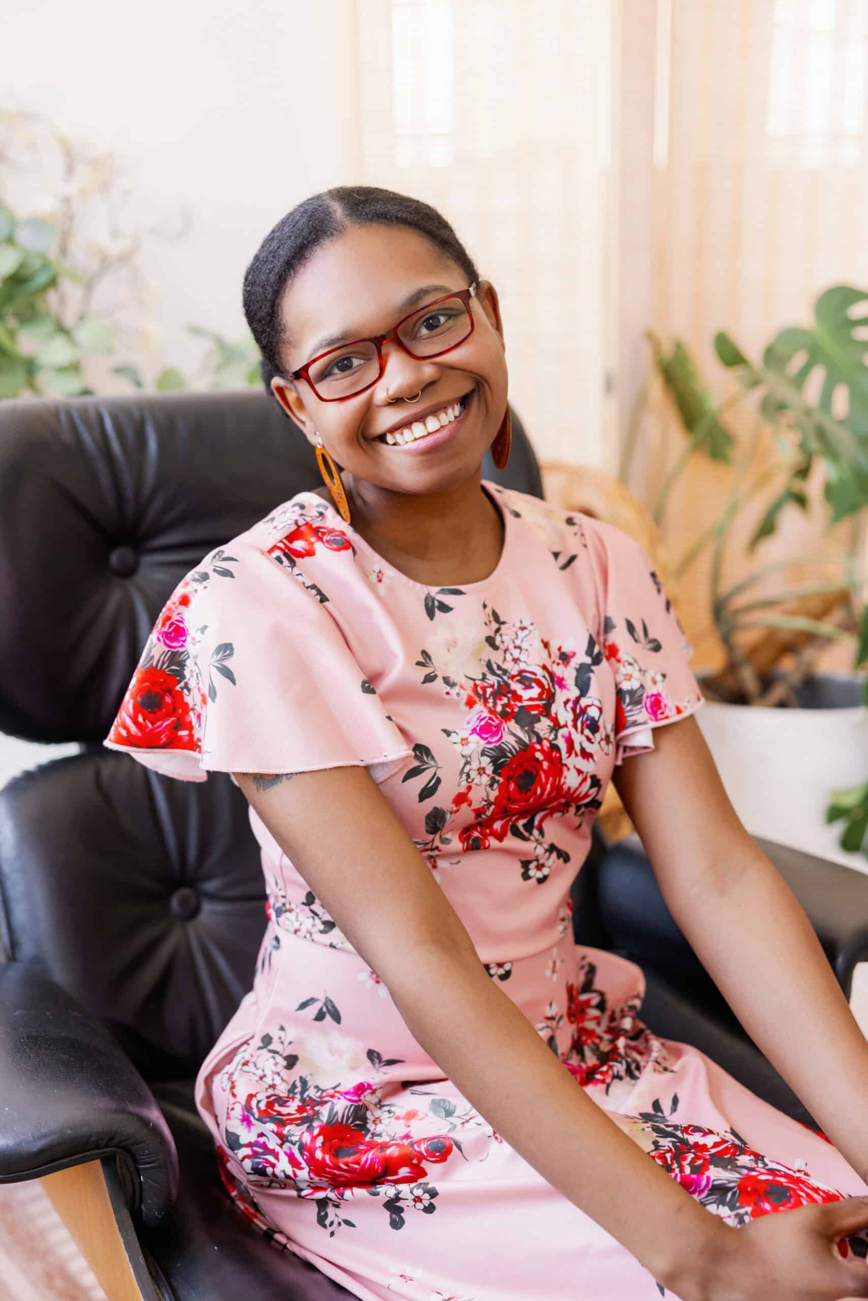 Brooke Scott Inclusive church member smiling in a floral dress at More Light Presbyterians office.